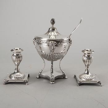 A silver bowl on foot, a pair of candlesticks and a spoon. early 20th century. Total weight app. 800 gram.