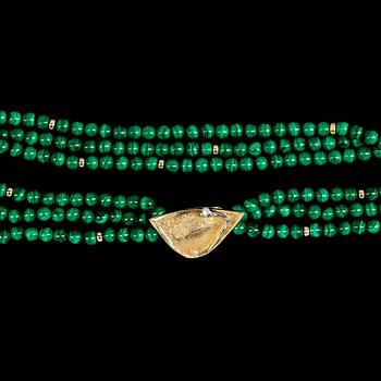 1004. Ole Lynggaard, NECKLACE, Ole Lyngaard, three strand malchite necklace, gold clasp with brilliant cut diamond, 0.06 cts.