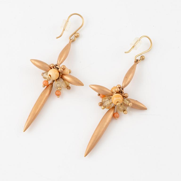 A pair of earrings in 14K and 9K gold with coral and quartz, by Ted Muehling purchased at Svenskt Tenn.