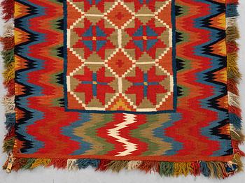 A carriage cushion, double-interlocked tapestry, ca 109,5 x 46 cm, Scania, Sweden.