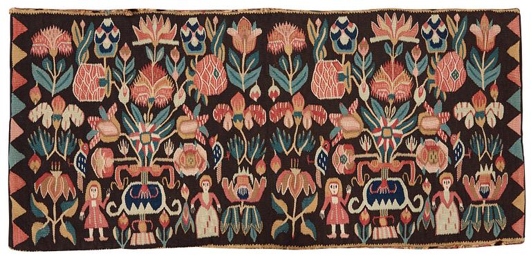 A CARRIAGE CUSHION. Tapestry weave. "Urnor och par". 48,5 x 101,5 cm. Southern Scania, Sweden, 19th century.