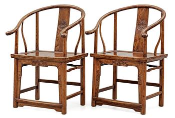1307. A pair of hardwood horseshoeback armchairs, Qing dynasty.