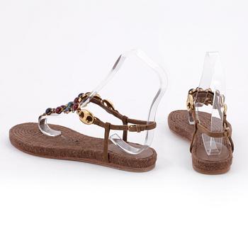 GUCCI, a pair of brown sandals.