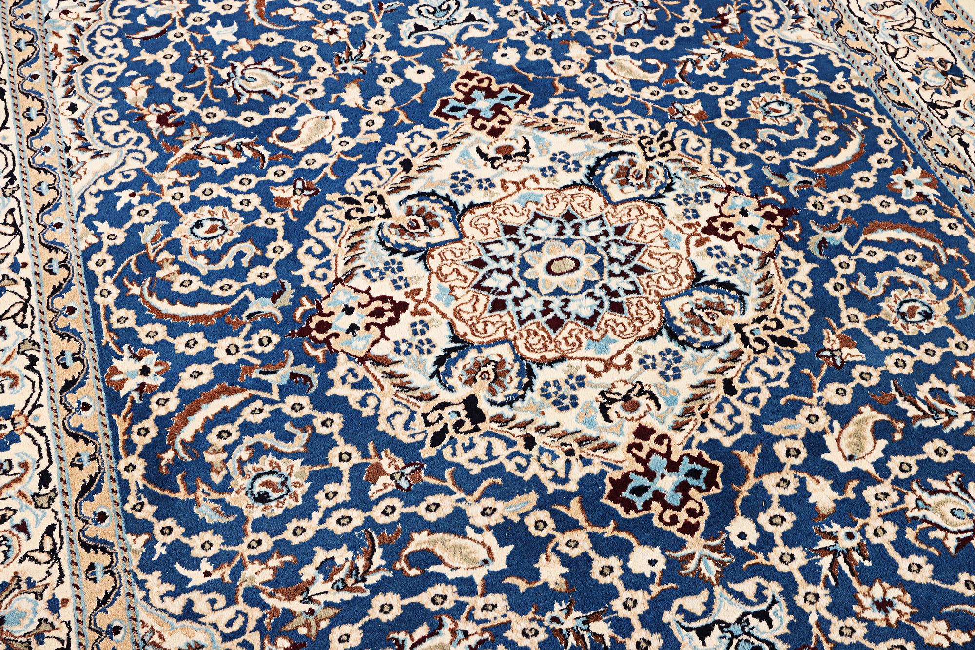 A Nain carpet, part silk, 9 laa, c. 300 x 189 cm.