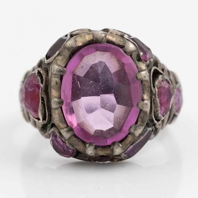 Silver ring with pink stones.