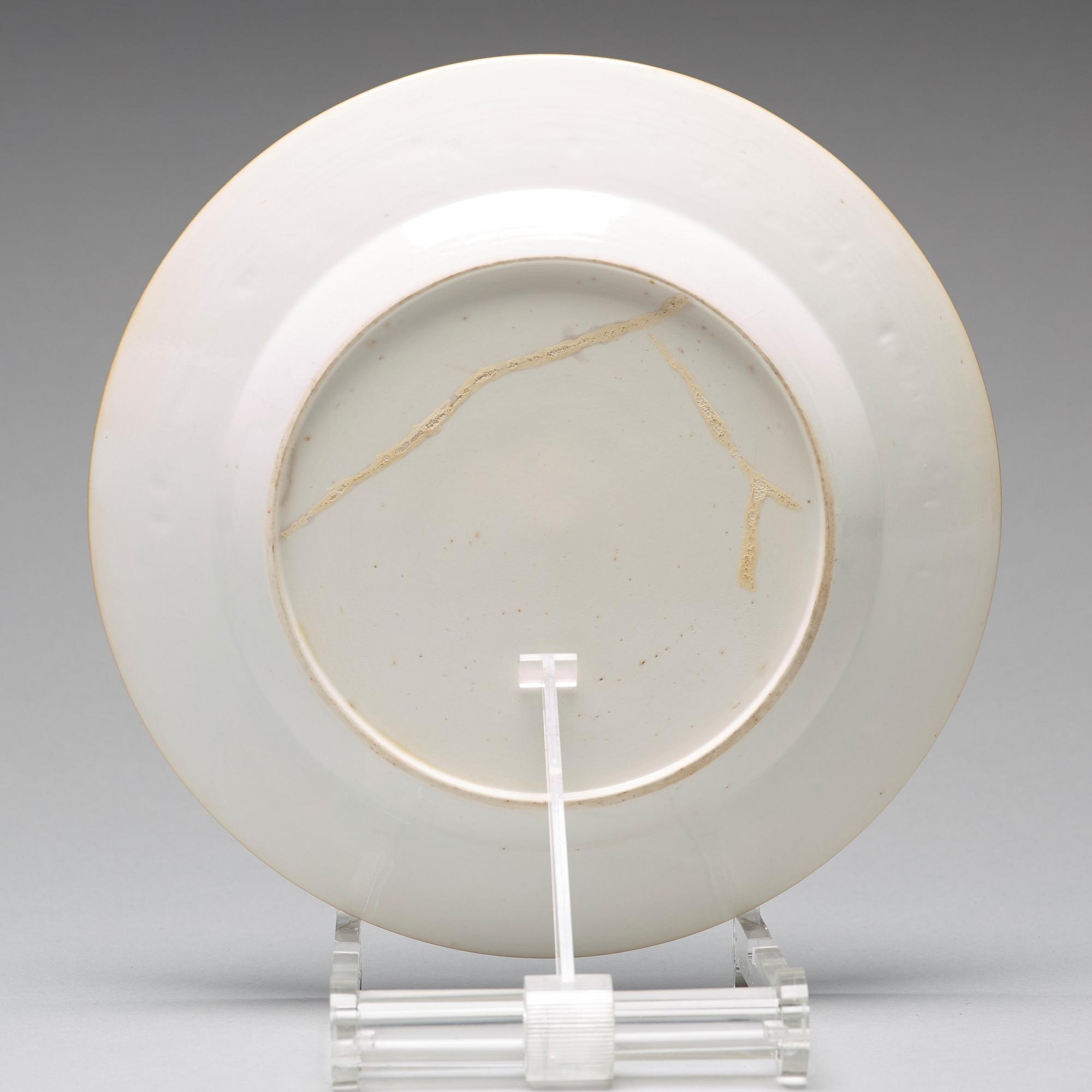 A set of four blue and white armorial dinner plates, Qing dynasty, 18th Century.