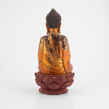 A gilt and lacquered figure of a seated buddha, late Qing dynasty.