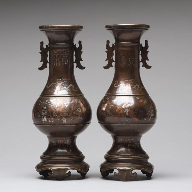 A pair of bronze vases with copper and silver inlay, Qing dynasty (1664-1912).