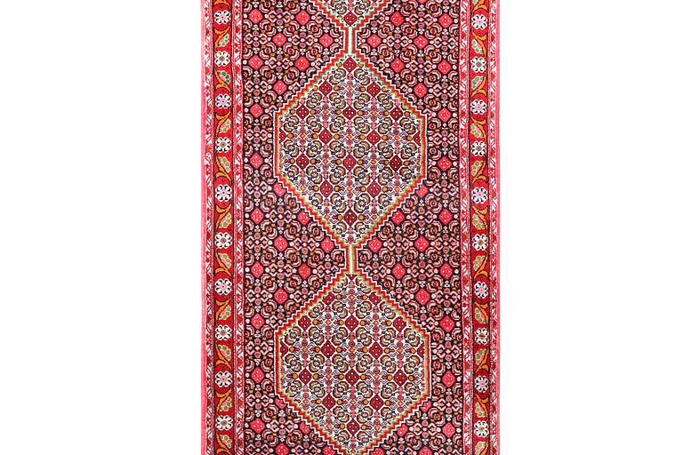 A Runner carpet, Senneh, c. 325 x 80 cm.