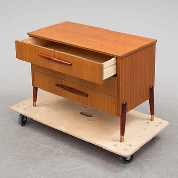 A 1950s teak veneer chest of drawers.