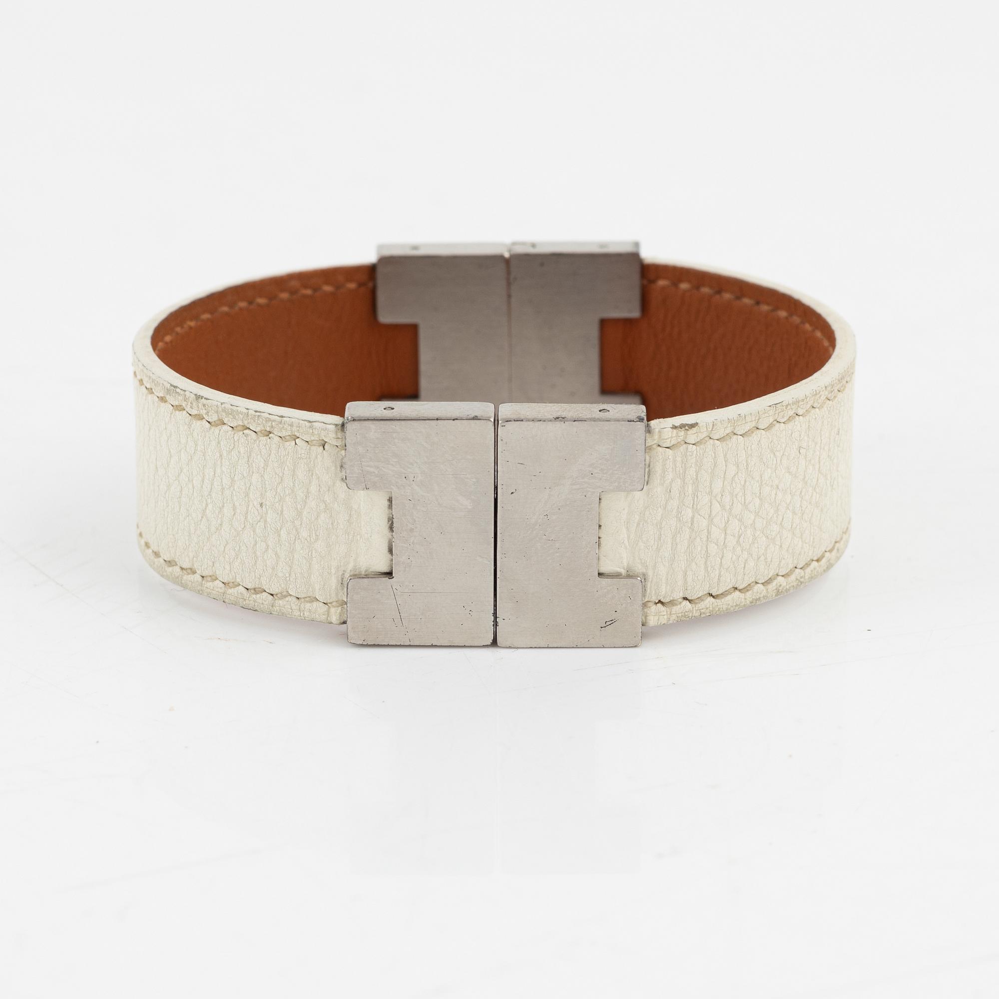 Hermès, a white leather bracelet.