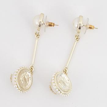 A pair of Chanel earrings.