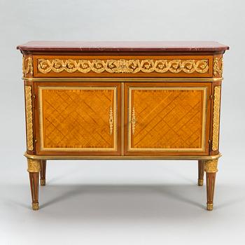 A French chest of drawer in Louis XVI style after Jean-Francois Leleu's school, late 19th century.
