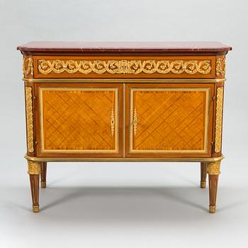 A French chest of drawer in Louis XVI style after Jean-Francois Leleu's school, late 19th century.