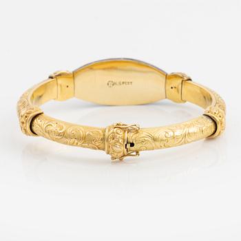 A bangle, gold, blue enamel, and rose cut diamonds.