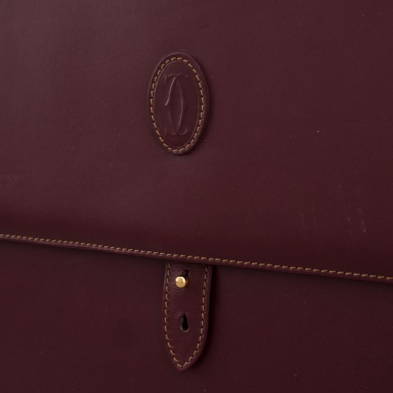 Wine-colored leather briefcase by Cartier.