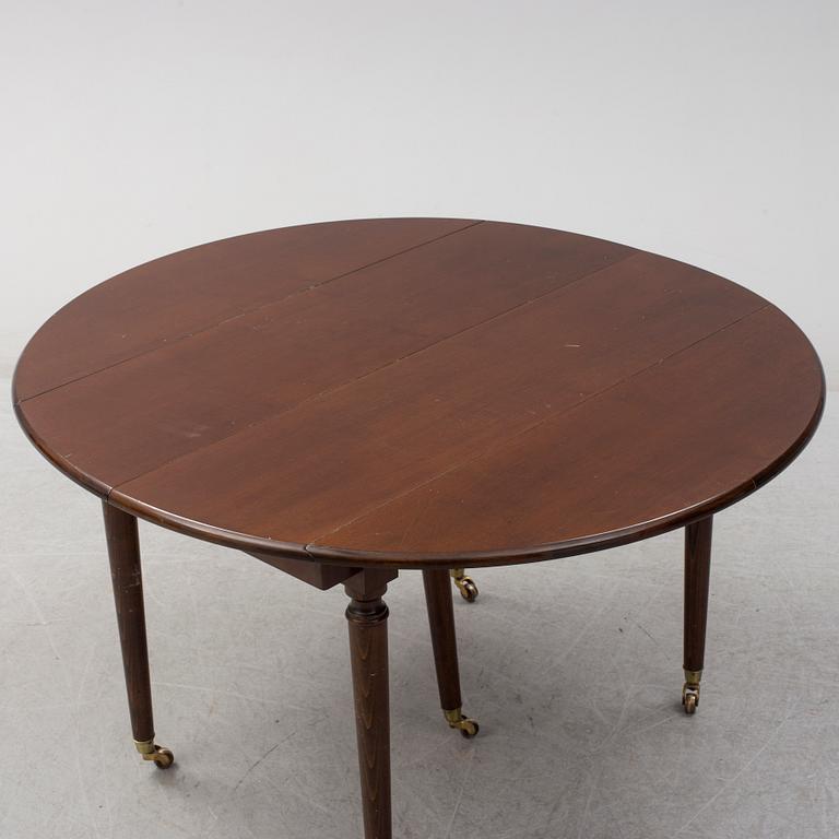 A mid 20th century mahogany veneered dining table by AB Harald Westerberg, Stockholm.