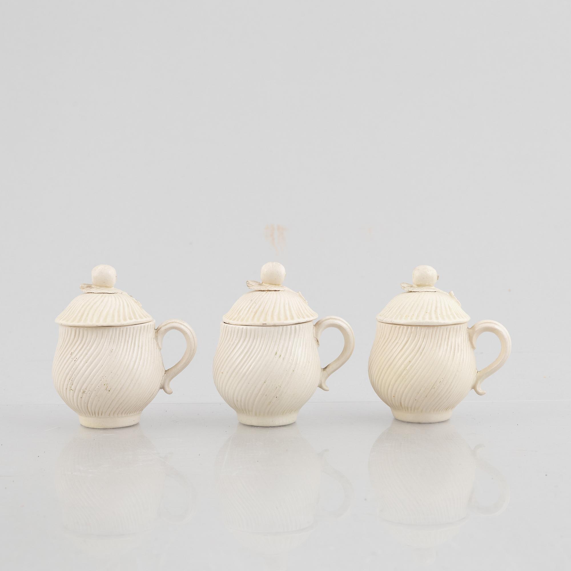 A set of six soft-paste porcelain custard cups with covers, 18th century.