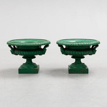 A pair of cast iron garden urns by Husqvarna, circa 1900.