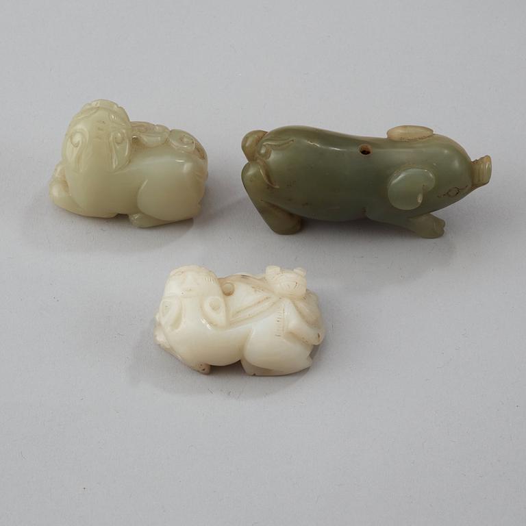 Three Chinese nephrite figure of two buddhist lions and a pig.