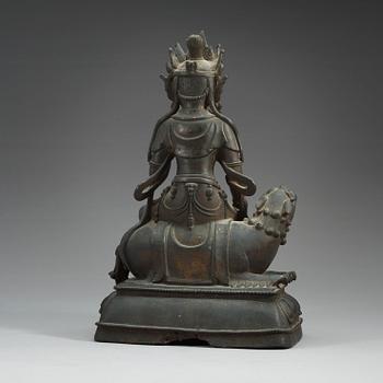 A large bronze figure of Bodhisattva seated on a mythical beast, Qing dynasty, 18/19th Century.