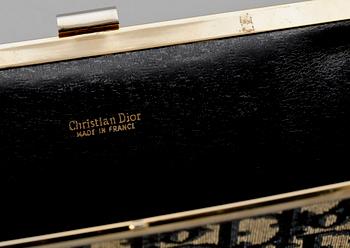 A blue monogram canvas clutch by Christian Dior.