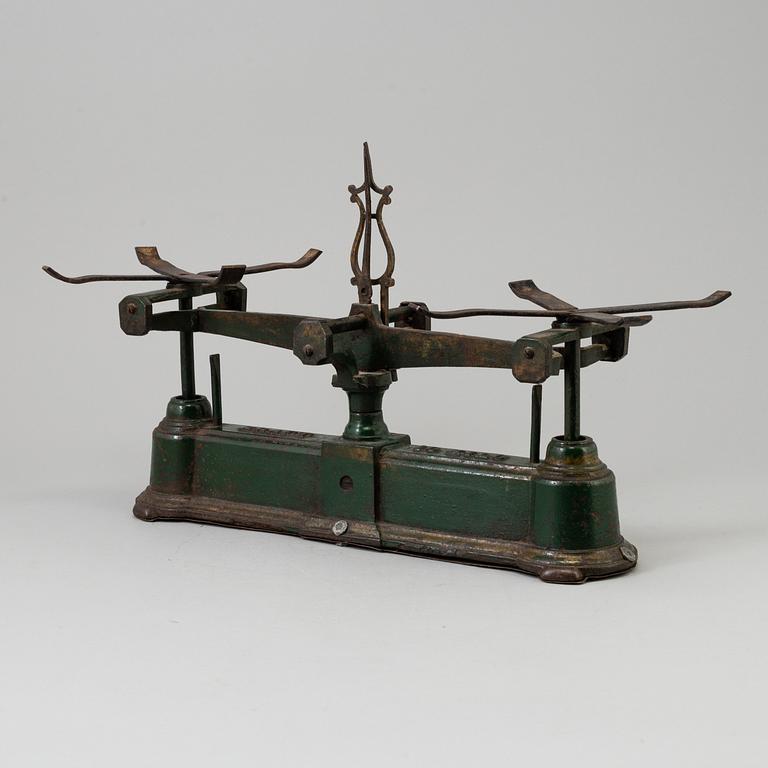 A 20th century cast iron balance with brass and iron weights, partly Skultuna, Sweden.