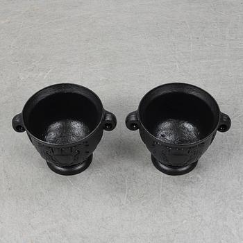 An early 20th Century pair of cast iron pots.