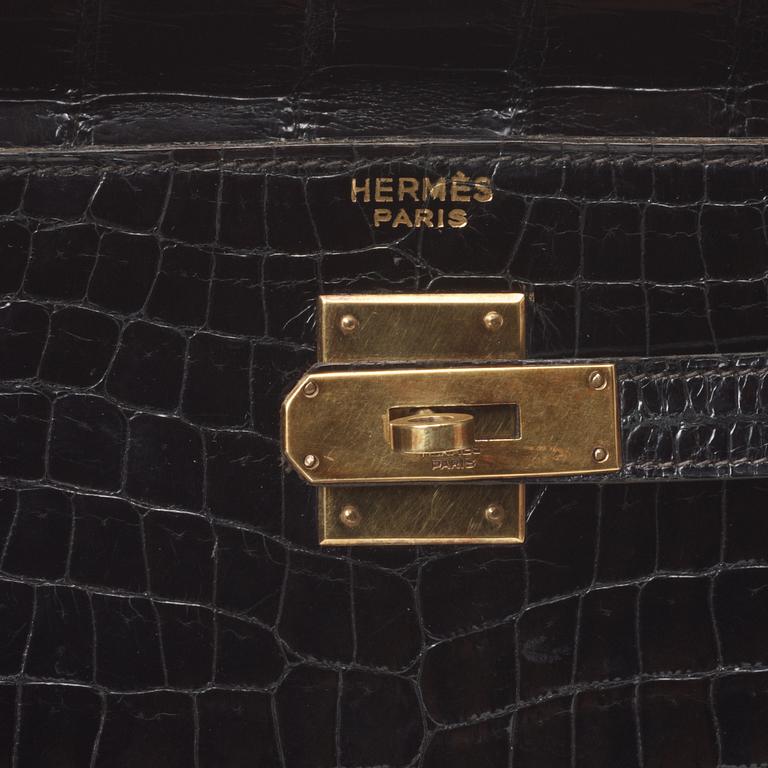 A 1960s/70s black crocodile leather handbag "Kelly" by Hermès.