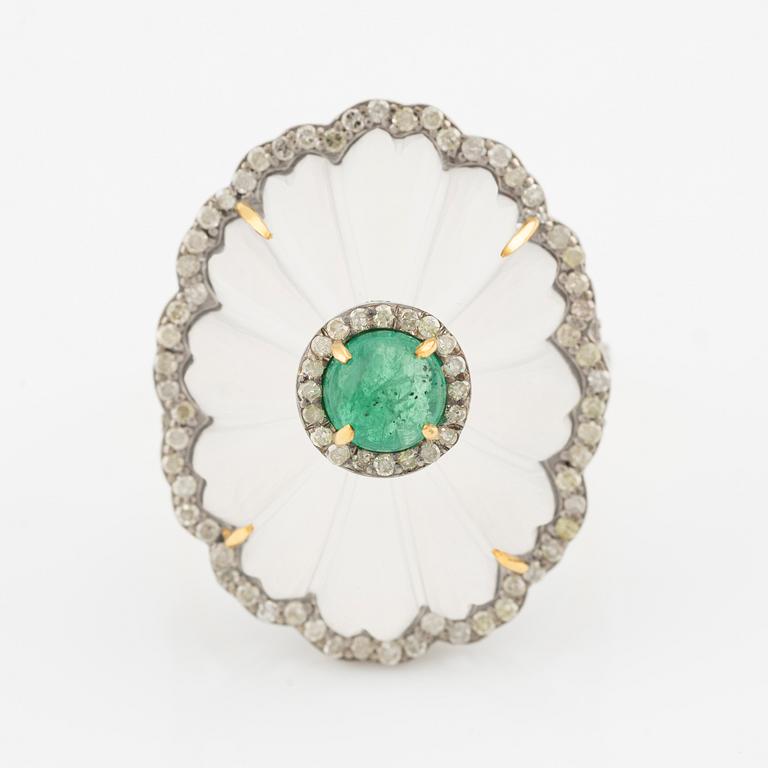 Ring with cut rock crystal, diamonds, and cabochon-cut emerald.