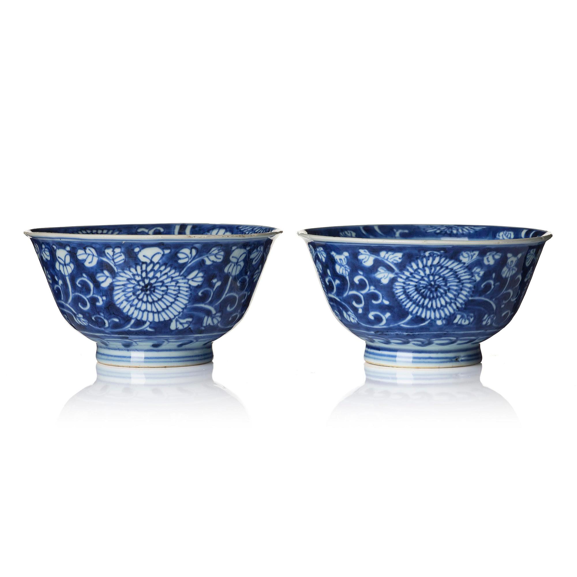 A pair of blue and white reverse decorated floral bowls, Qing dynasty, Kangxi (1662-1722).