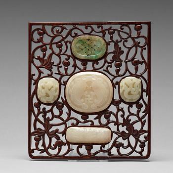 605. A set of four carved nephrite objects on a wooden frame, Qing dynasty (1664-1912).