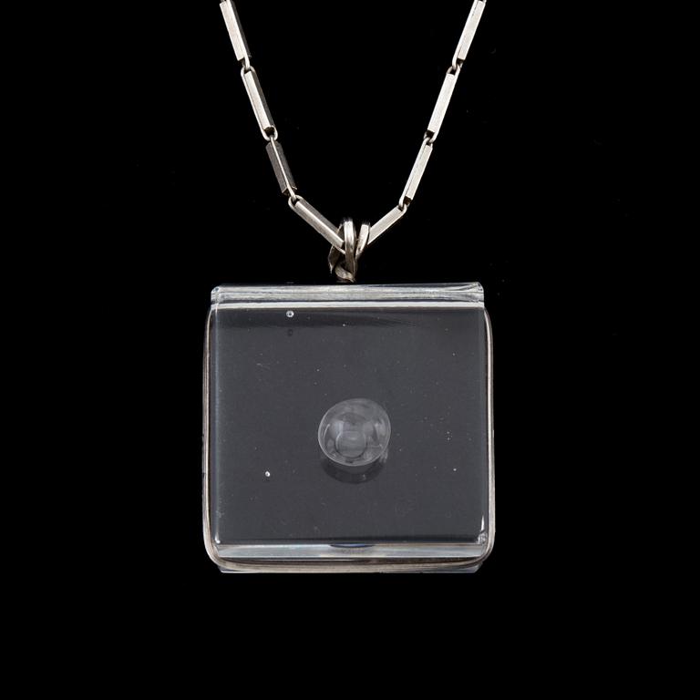 A glass pendant designed by Gunnar Cyrén and a silver necklace.