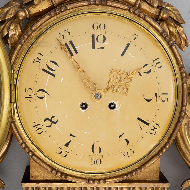 A Gustavian style wall clock, circa 1900.