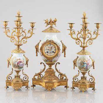 A Louis XVI-style set with a mantle clock and two urns, presumably France, second half of the 19th century.
