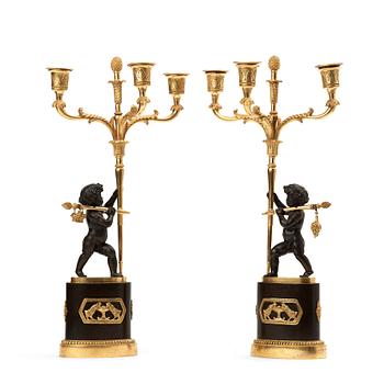 83. A pair of French Empire early 19th century three-light candelabra.