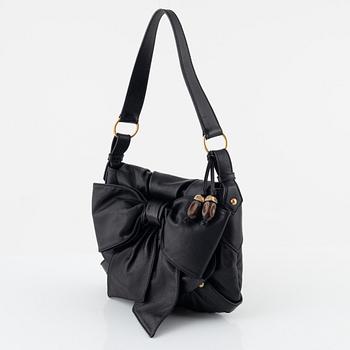 Yves Saint Laurent, a black leather bow bag.