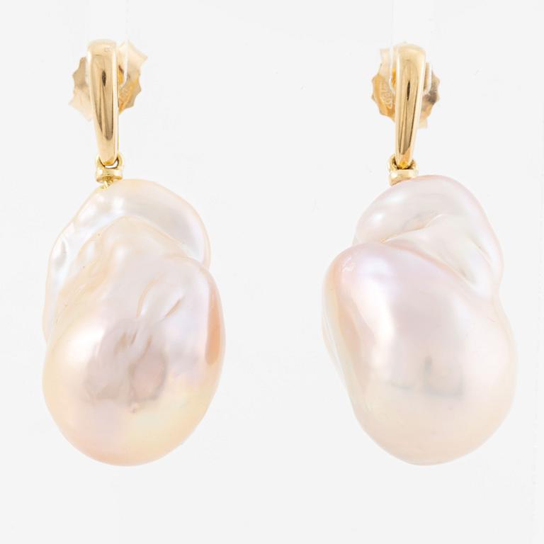 A pair of earrings in 18K gold with cultured freshwater pearls.