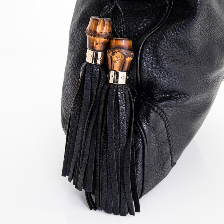 Gucci, a 'Bamboo Jackie Tassel' shoulder bag.