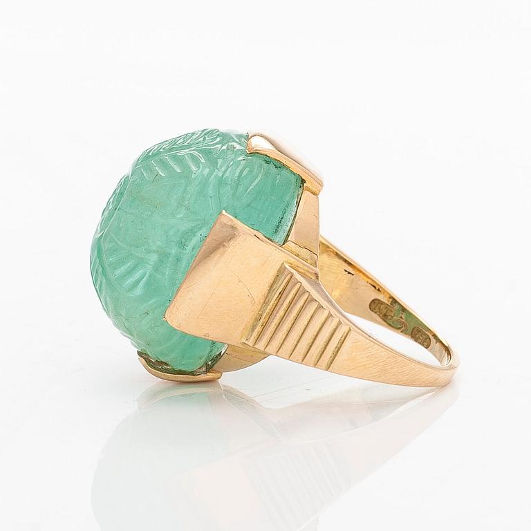 An 18K gold ring with a cabochon-cut emerald, import-stamped A. Tillander.