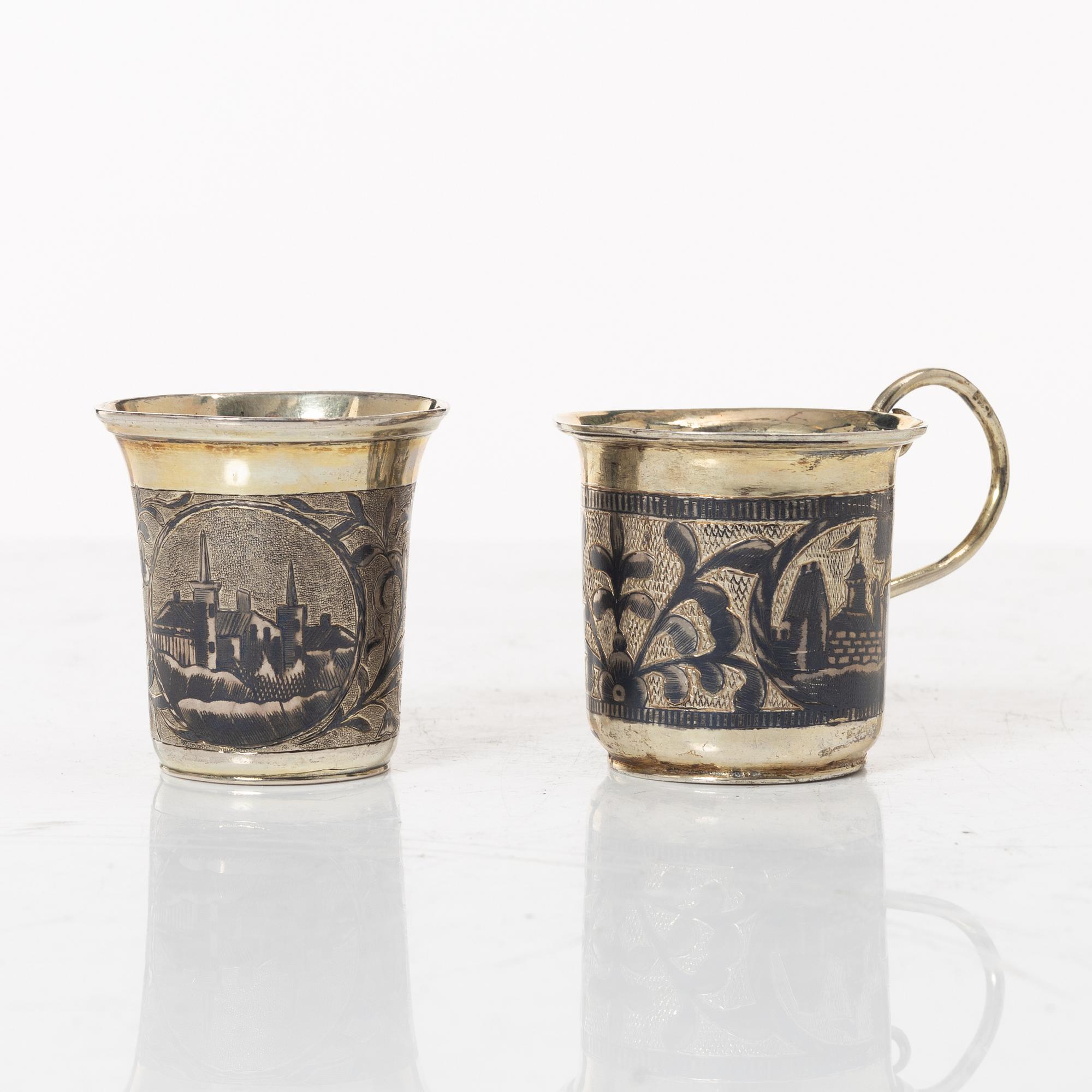 Two Russian parcel-gilt silver niello vodka cups, Moscow 1832 and 1845.