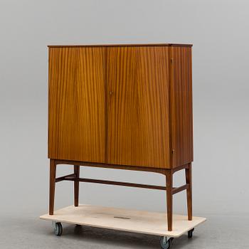 A 1950s mahogany veneered cabinet.