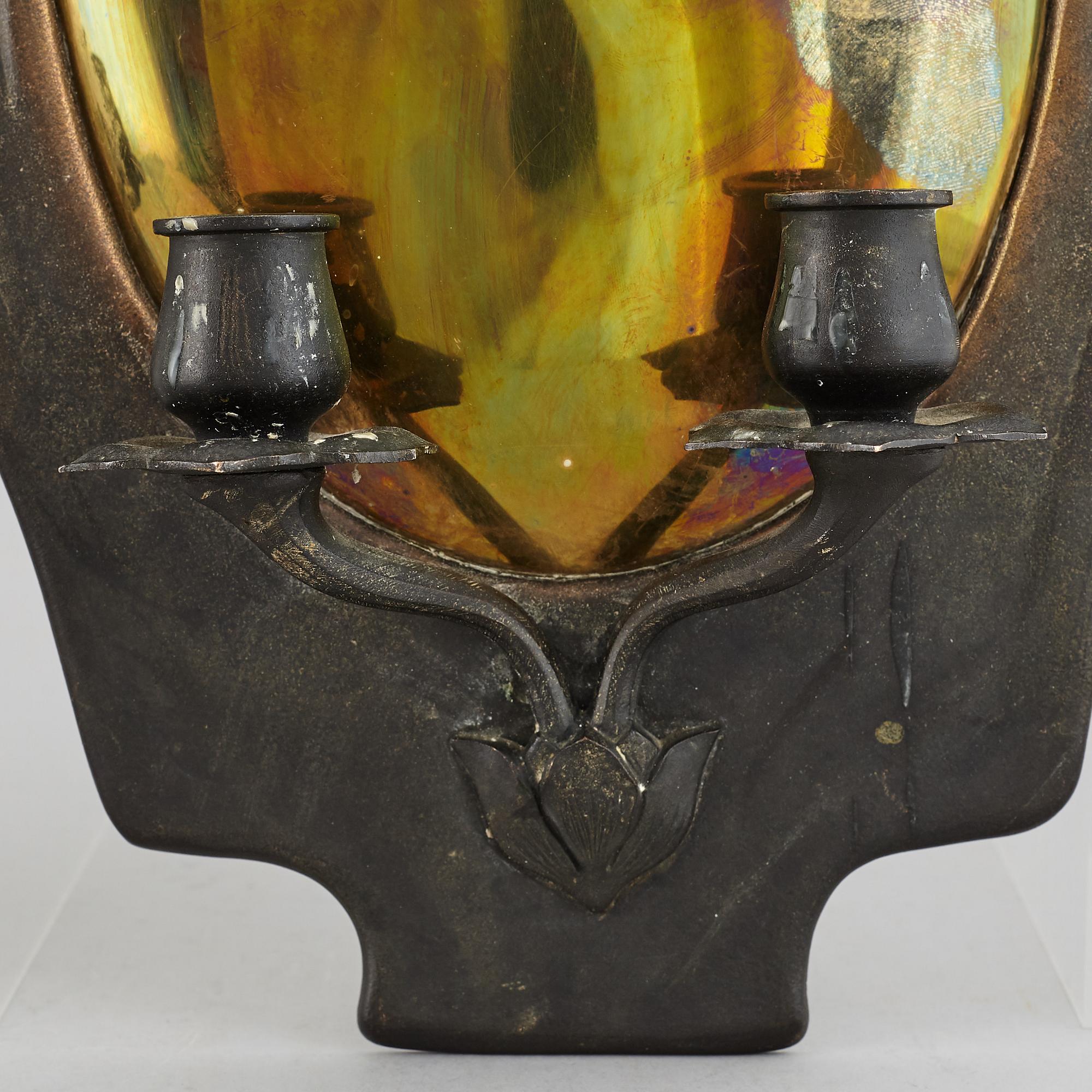 A pair of bronze and brass wall sconces from the early 20th century.