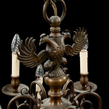 A patinated brass chandelier, first half of the 20th century. Height excl. chain ca 75 cm.