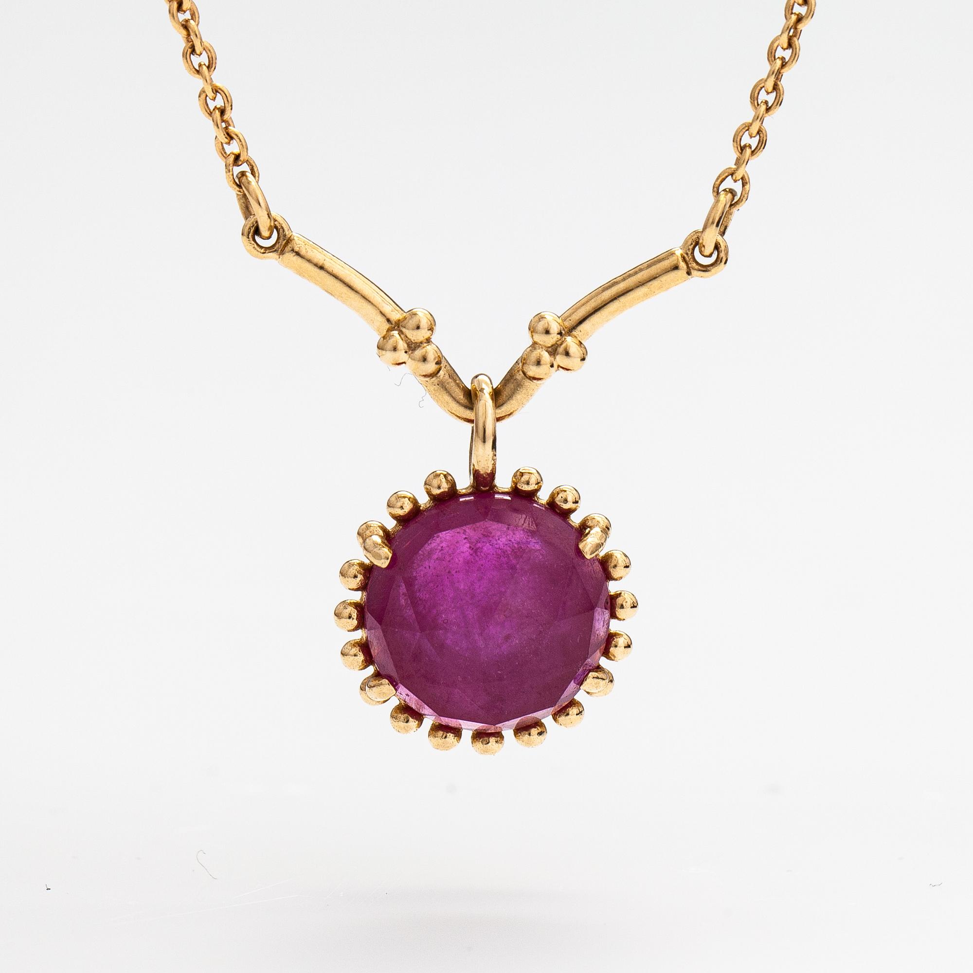 Pandora, a necklace with a lead glass treated ruby.
