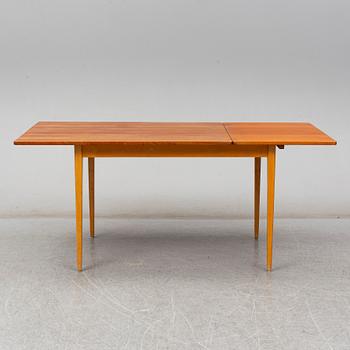A 1960s teak veneered dining table.
