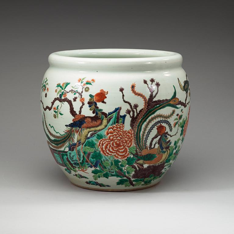 A famille rose jardiniere, decorated with a terrace scene with blossom and birds, late Qing dynasty, about 1900.