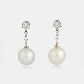 1121. A pair of cultured South Sea Pearl earrings in 18K white gold set with round brilliant-cut diamonds.