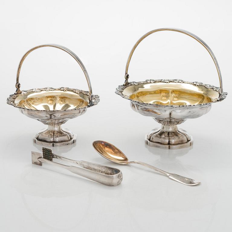 A set of two 1920s-1930s silver sweetmeat basket with sugar tong and jam spoon, Uusi Kultaseppä Oy, Helsinki, Finland.