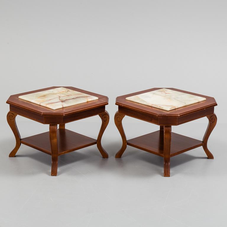 a pair of mahogany and marble tables from the late 20th century.